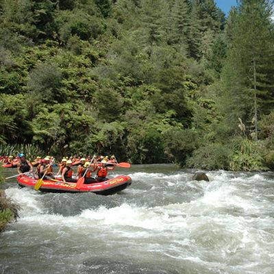 a group of people on a raft in a body of water