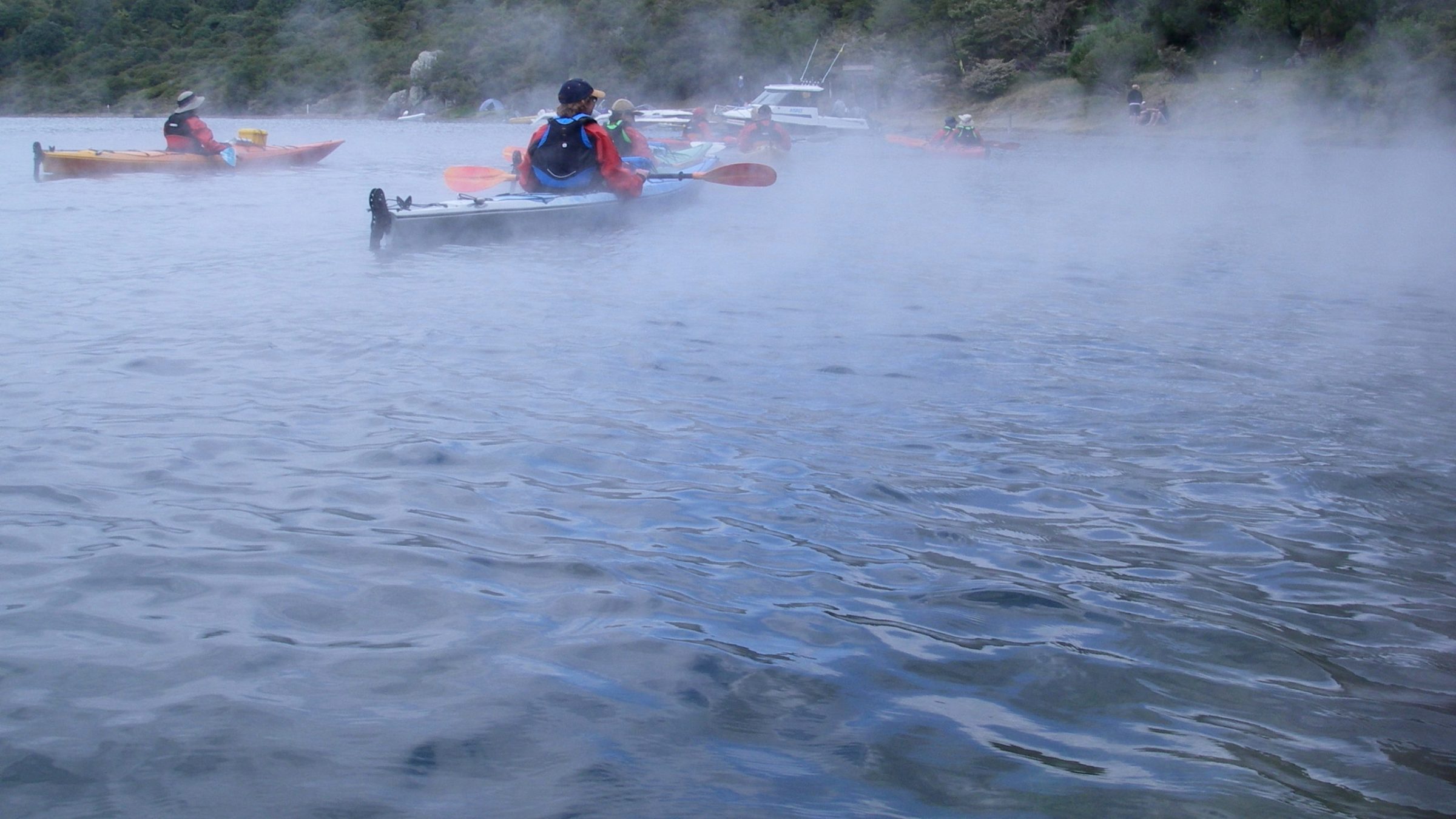 a group of people riding skis on a body of water