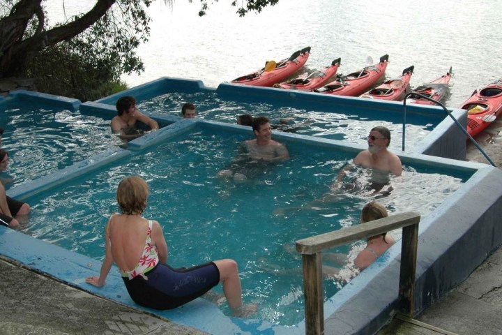 a group of people sitting in a swimming pool
